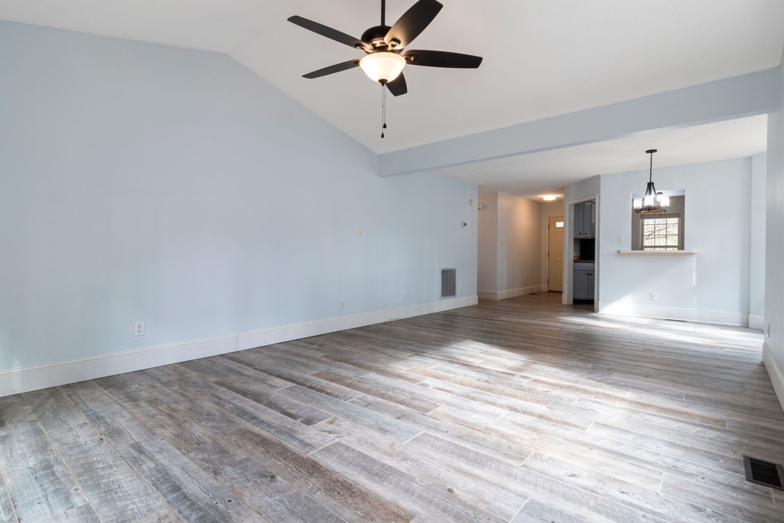 An empty open room with soft grey-blue painted walls